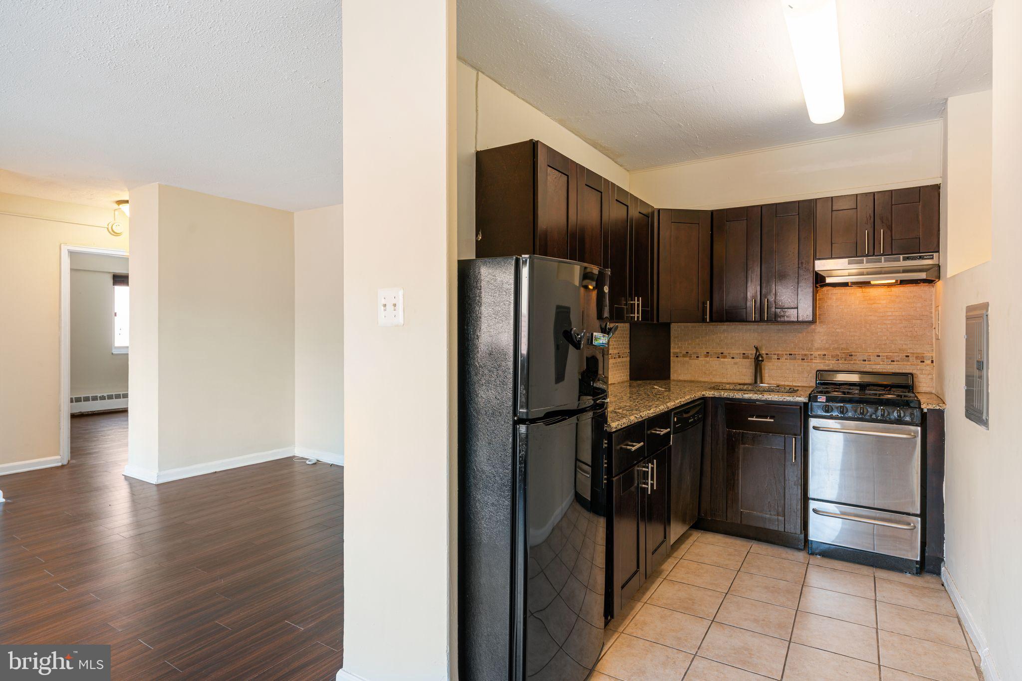 2101 Chestnut Street, Unit 518 Philadelphia, PA 19103 - Photo 6 of 14 a kitchen with stainless steel appliances granite countertop a refrigerator stove and oven