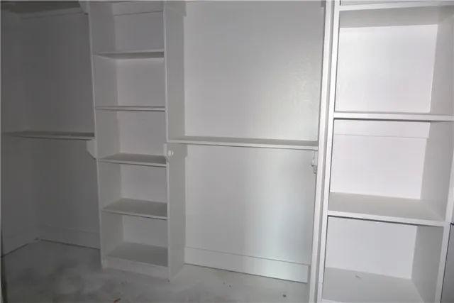 a walk in closet with empty racks