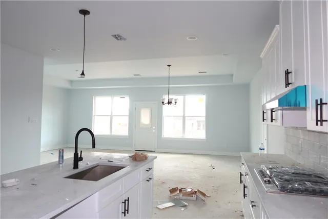 a kitchen with a sink and a stove top oven