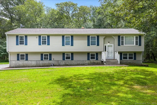 a view of house with a yard