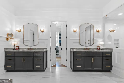a kitchen with cabinets appliances and a wooden floor