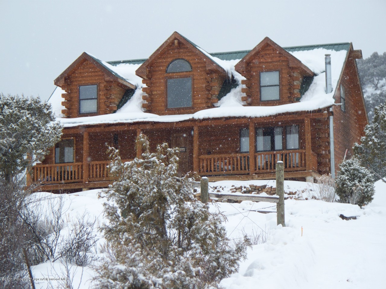 142 Jensen Lane Rifle, CO 81650 - Photo 3 of 11 a front view of a house with a yard and covered with snow