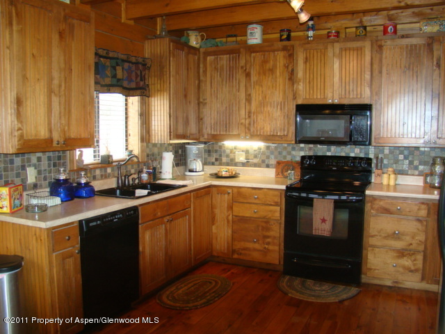 142 Jensen Lane Rifle, CO 81650 - Photo 8 of 11 a kitchen with a refrigerator and a stove top oven