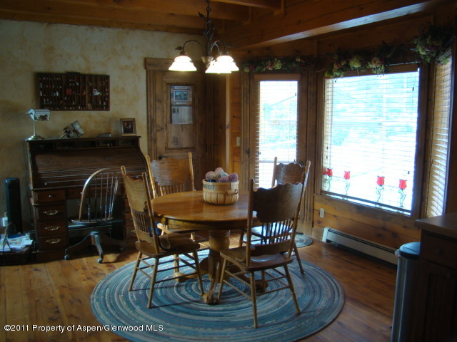 142 Jensen Lane Rifle, CO 81650 - Photo 9 of 11 a dining room with furniture a chandelier and wooden floor