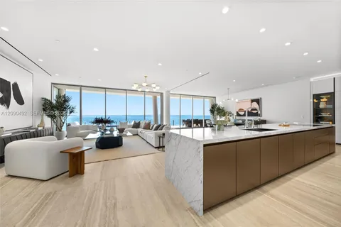 a large living room with stainless steel appliances granite countertop a couch and a couch