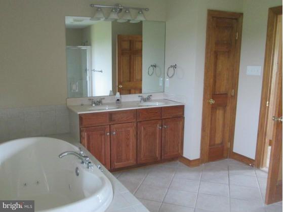 4354 Valley View Road Middletown, MD 21769 - Photo 14 of 20 a bathroom with a bathtub and a sink