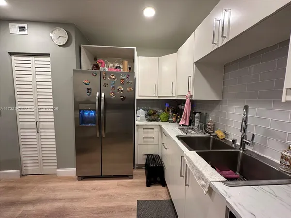 a kitchen with a sink cabinets and stainless steel appliances