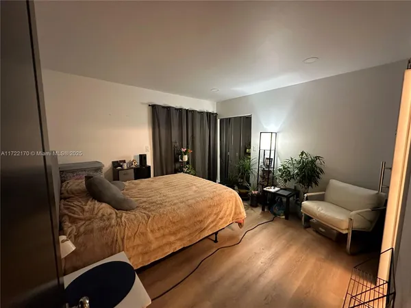 a bedroom with a bed and a couch