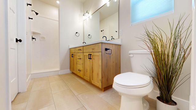 1127 4240 North Enoch, UT 84721 - Photo 22 of 56 Master Full bath featuring double vanity, light tile patterned floors, and a shower