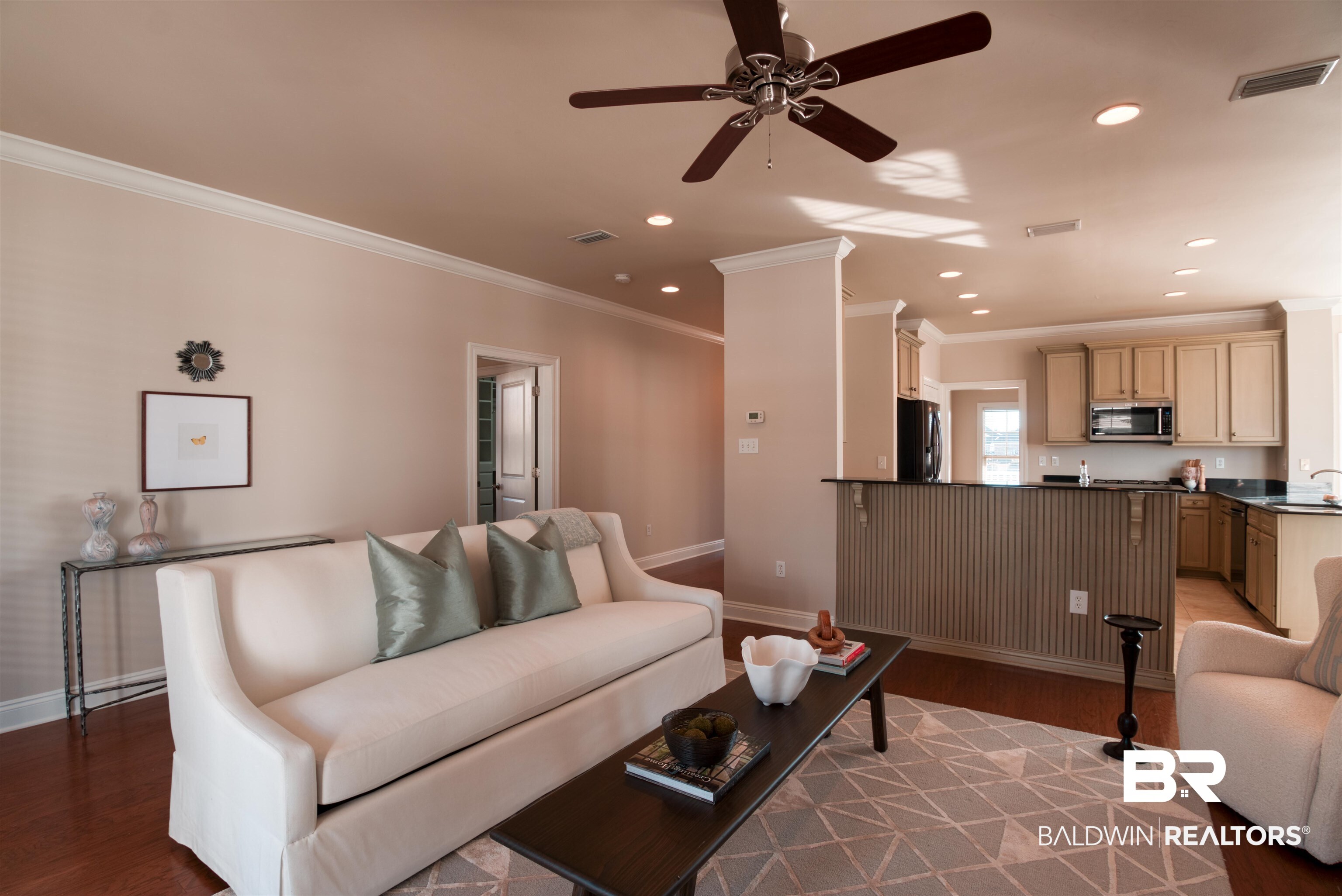 24561 Austin Road Daphne, AL 36526 - Photo 18 of 57 Living room featuring ceiling fan, crown molding, sink, and light hardwood / wood-style flooring