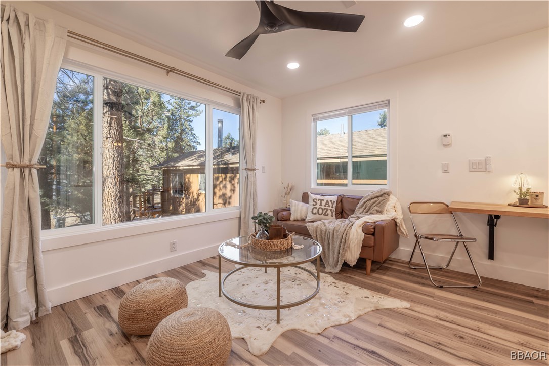 243 Riverside Avenue Sugarloaf, CA 92386 - Photo 8 of 24 a living room with furniture and floor to ceiling windows