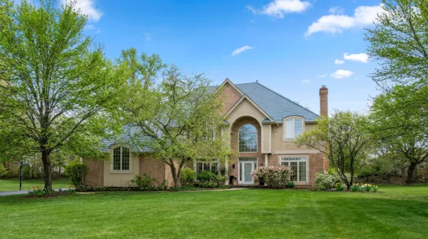 a front view of house with yard and green space