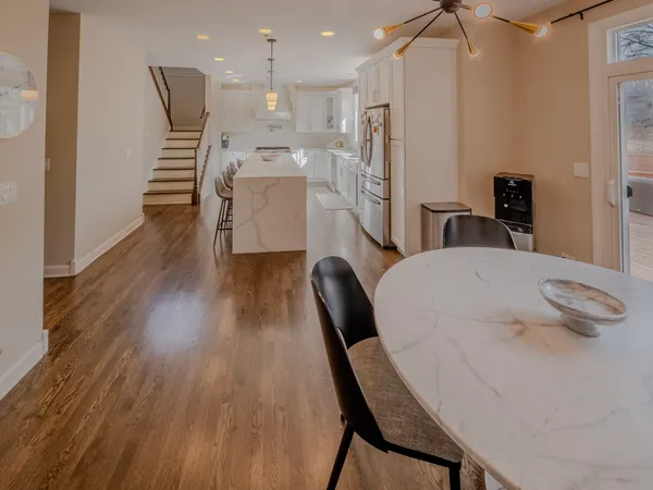 a dining room with furniture and wooden floor