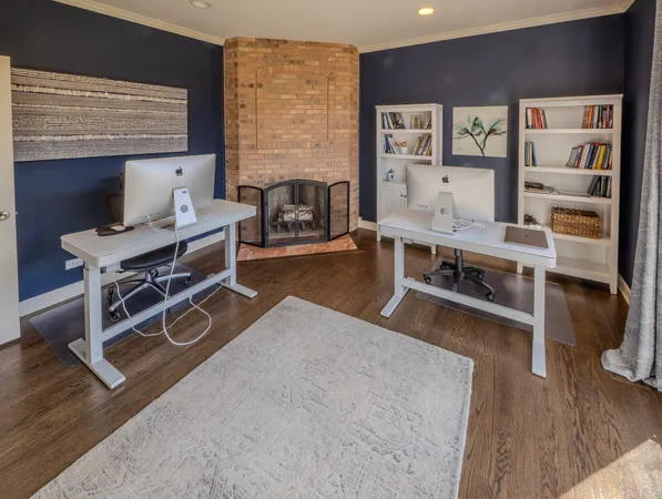 a living room with furniture a wooden floor and next to a window