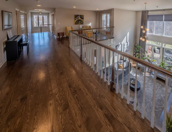 a view of a porch with wooden floor and windows