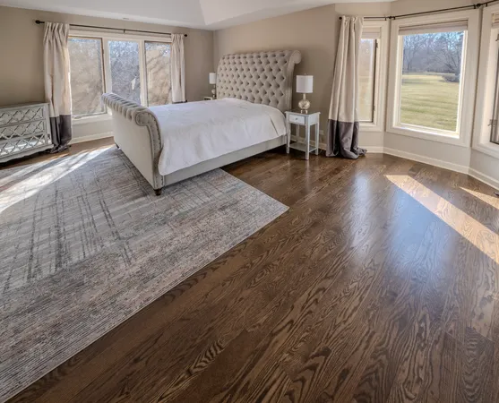 a bedroom with a bed and large window