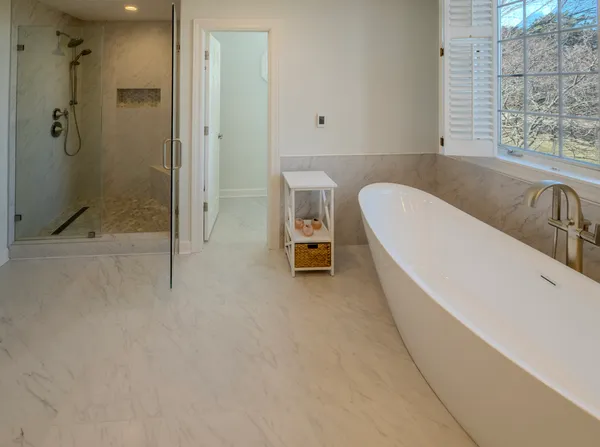 a bathroom with a bathtub and a shower