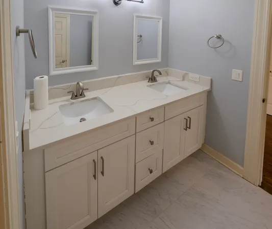 a bathroom with a double vanity sink and mirror
