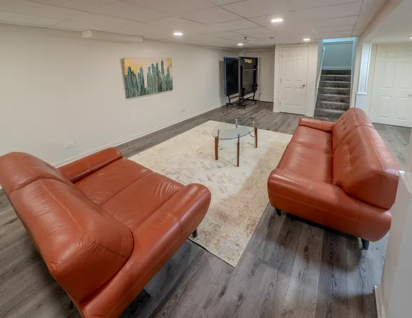 a projector room with furniture and a wooden floor