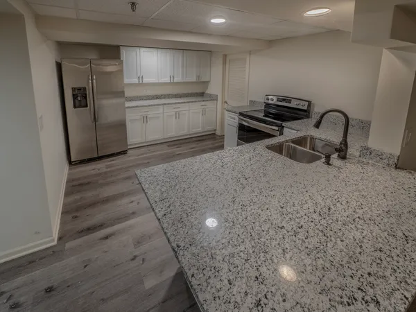 a kitchen with granite countertop a sink and a stove