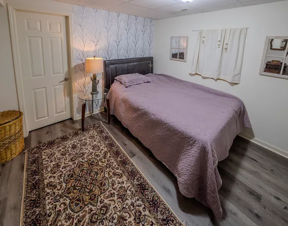 a bed sitting in a bedroom next to a window