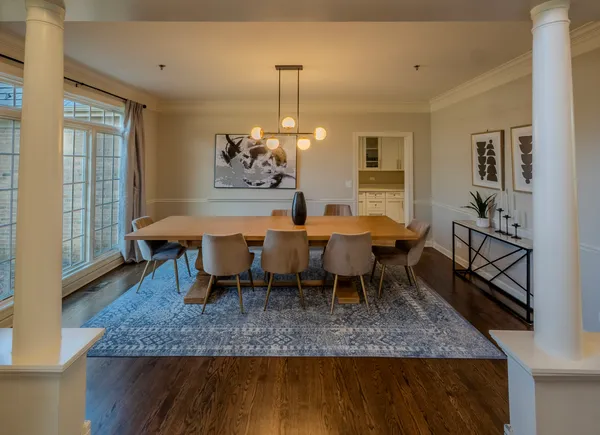 a dining room with furniture a rug and a chandelier