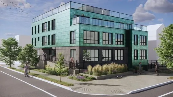a view of a brick building next to a yard