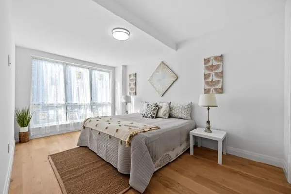 a bedroom with a bed and a window