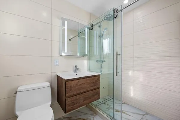 a bathroom with a toilet a sink and shower