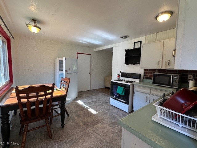 3216 South Ridge Road West Ashtabula, OH 44004 - Photo 8 of 17 Kitchen featuring white appliances and white cabinetry