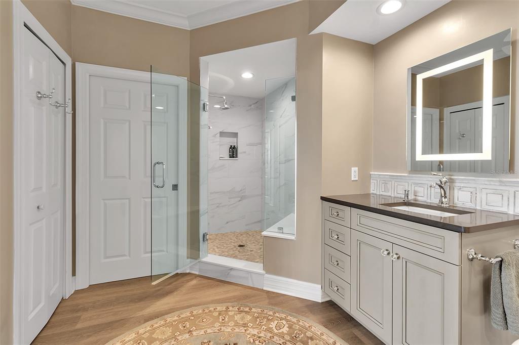 393 North Point Road, Unit 401 Osprey, FL 34229 - Photo 51 of 62 a bathroom with a granite countertop sink a mirror and a bathtub