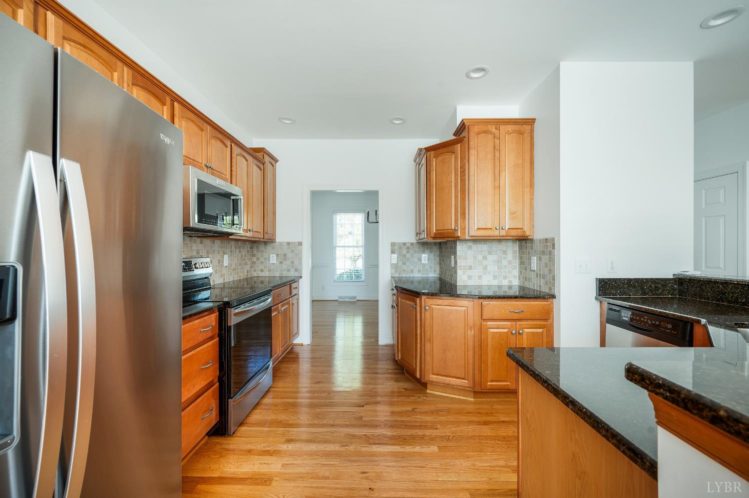 1166 Caperton Way Forest, VA 24551 - Photo 12 of 59 a kitchen with stainless steel appliances granite countertop a refrigerator a stove top oven a sink and dishwasher