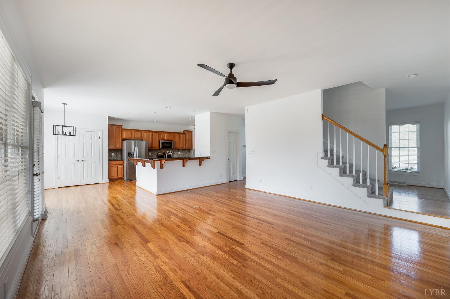 1166 Caperton Way Forest, VA 24551 - Photo 19 of 59 a view of a livingroom with wooden floor and a ceiling fan