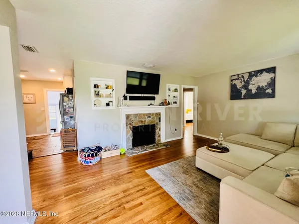 a living room with furniture and a fireplace