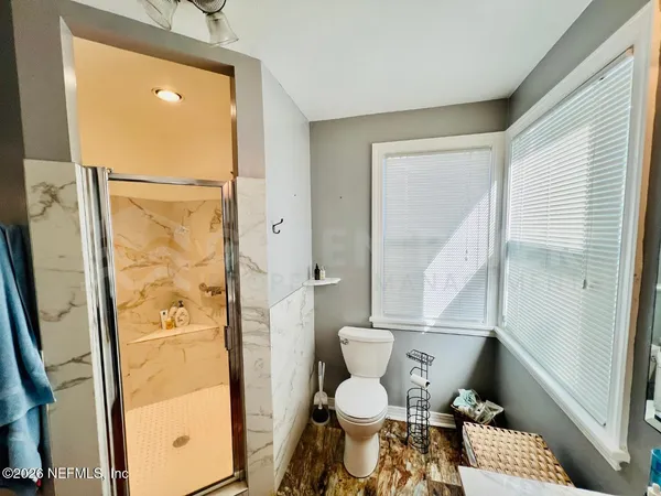 a bathroom with a toilet and a shower