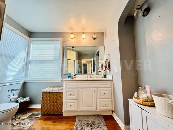 a living room with furniture and a mirror