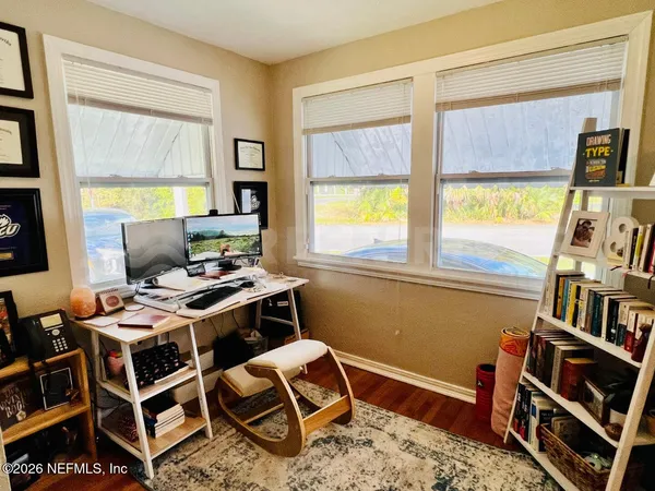 a workspace with furniture and a book shelf