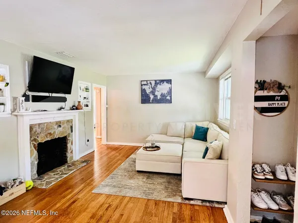 a living room with furniture a flat screen tv and a fireplace