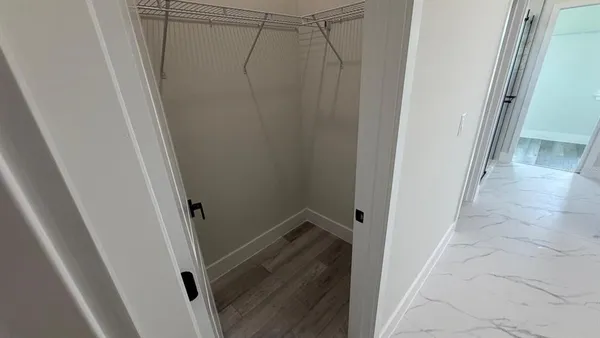 a bathroom with a glass shower door and a window
