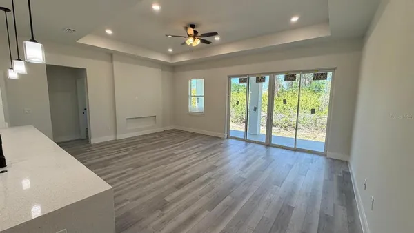 a kitchen with kitchen island granite countertop a sink window and stainless steel appliances