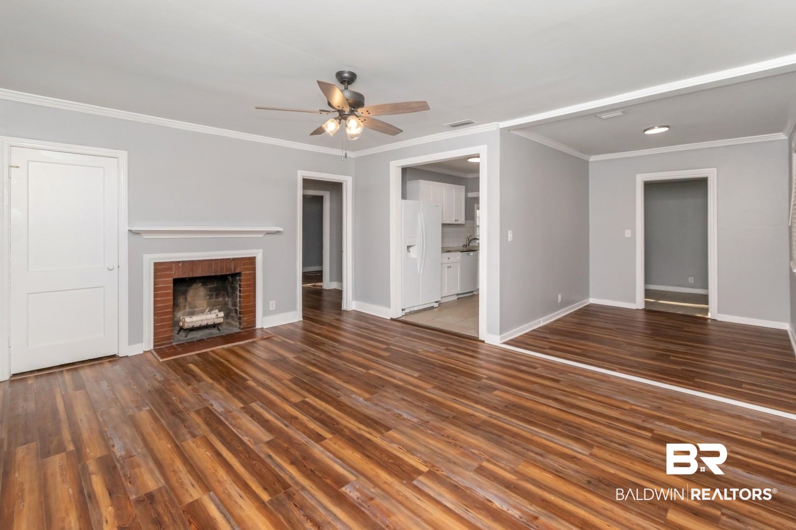 263 Border Drive East Mobile, AL 36608 - Photo 3 of 27 Living space featuring wood-finish flooring, light gray walls, a brick fireplace with a white mantel, white trim, and a ceiling fan