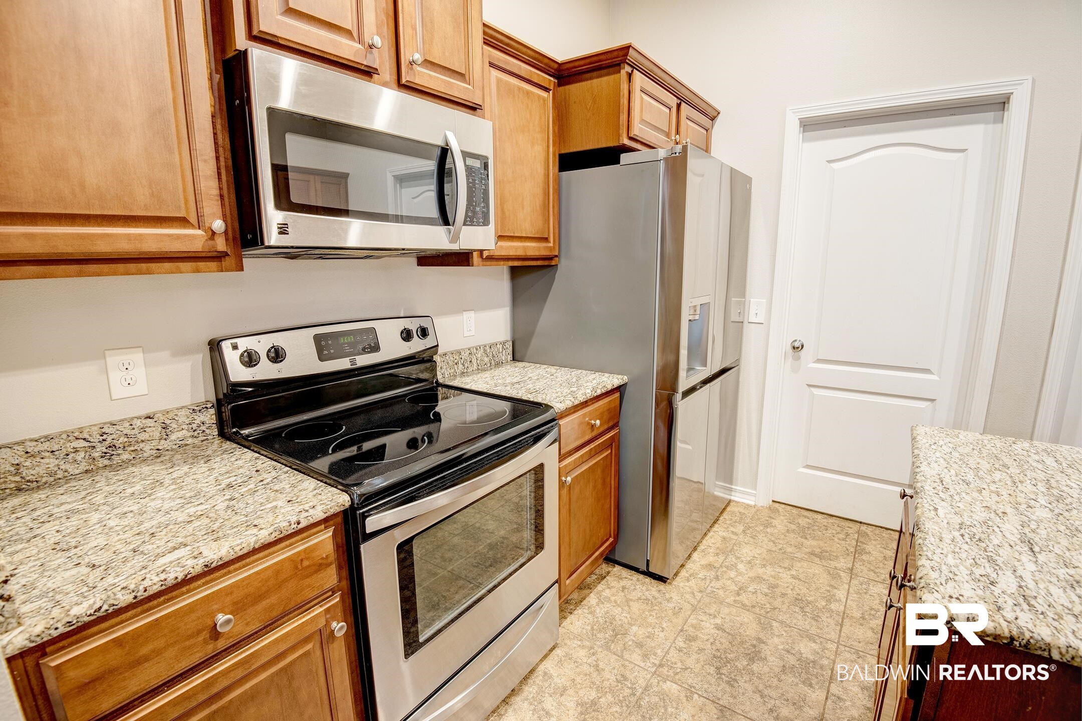 15345 Fremont Court Foley, AL 36535 - Photo 13 of 35 Kitchen featuring light stone countertops, light tile patterned flooring, and stainless steel appliances