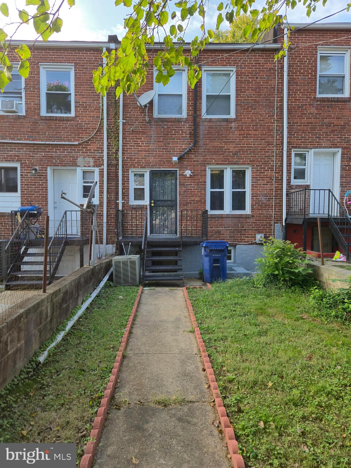 721 Roundview Road Baltimore, MD 21225 - Photo 16 of 30 a front view of house with yard and green space
