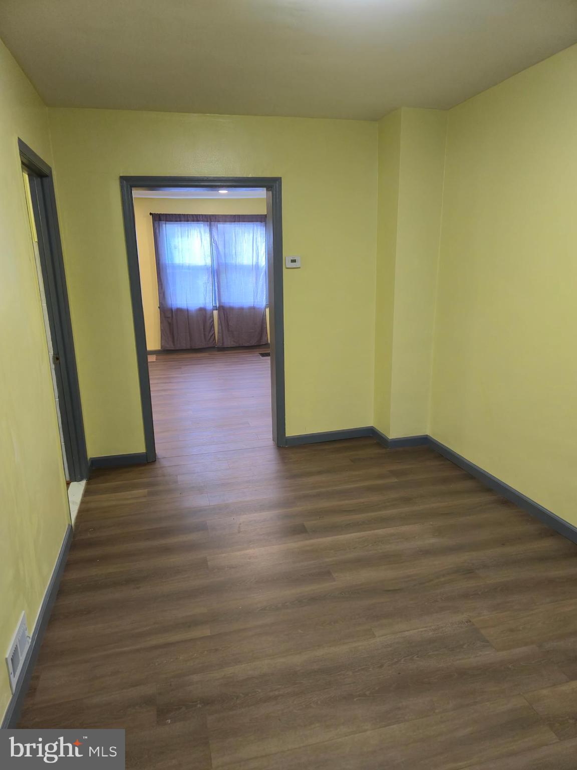 721 Roundview Road Baltimore, MD 21225 - Photo 17 of 30 a view of empty room with wooden floor