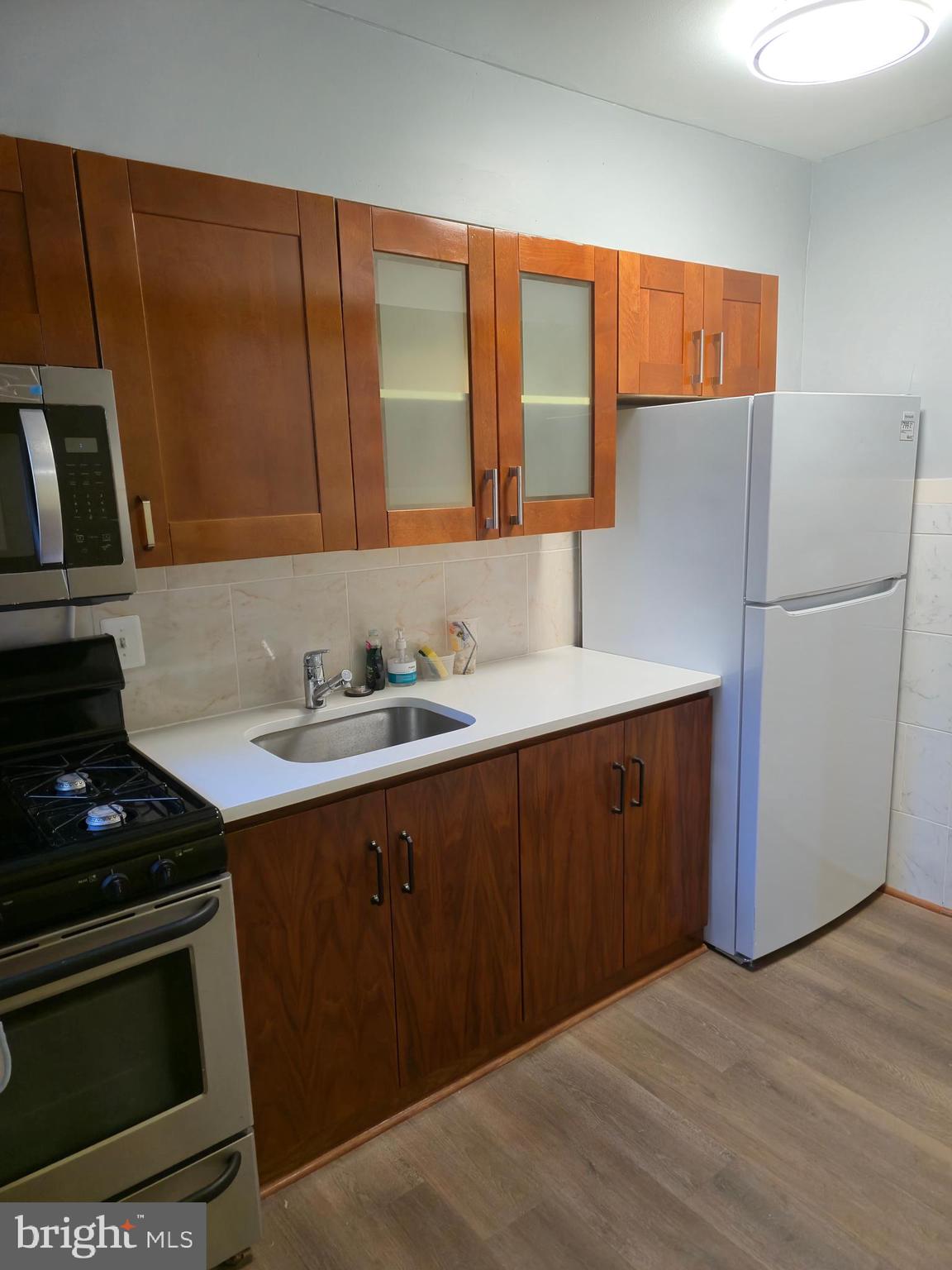 721 Roundview Road Baltimore, MD 21225 - Photo 20 of 30 a kitchen with stainless steel appliances a stove a sink and a refrigerator