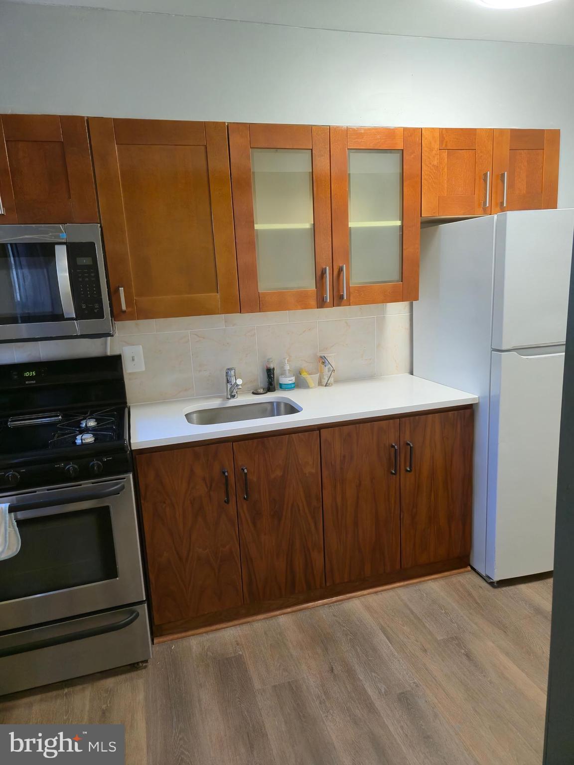 721 Roundview Road Baltimore, MD 21225 - Photo 21 of 30 a kitchen with a sink a stove and a microwave
