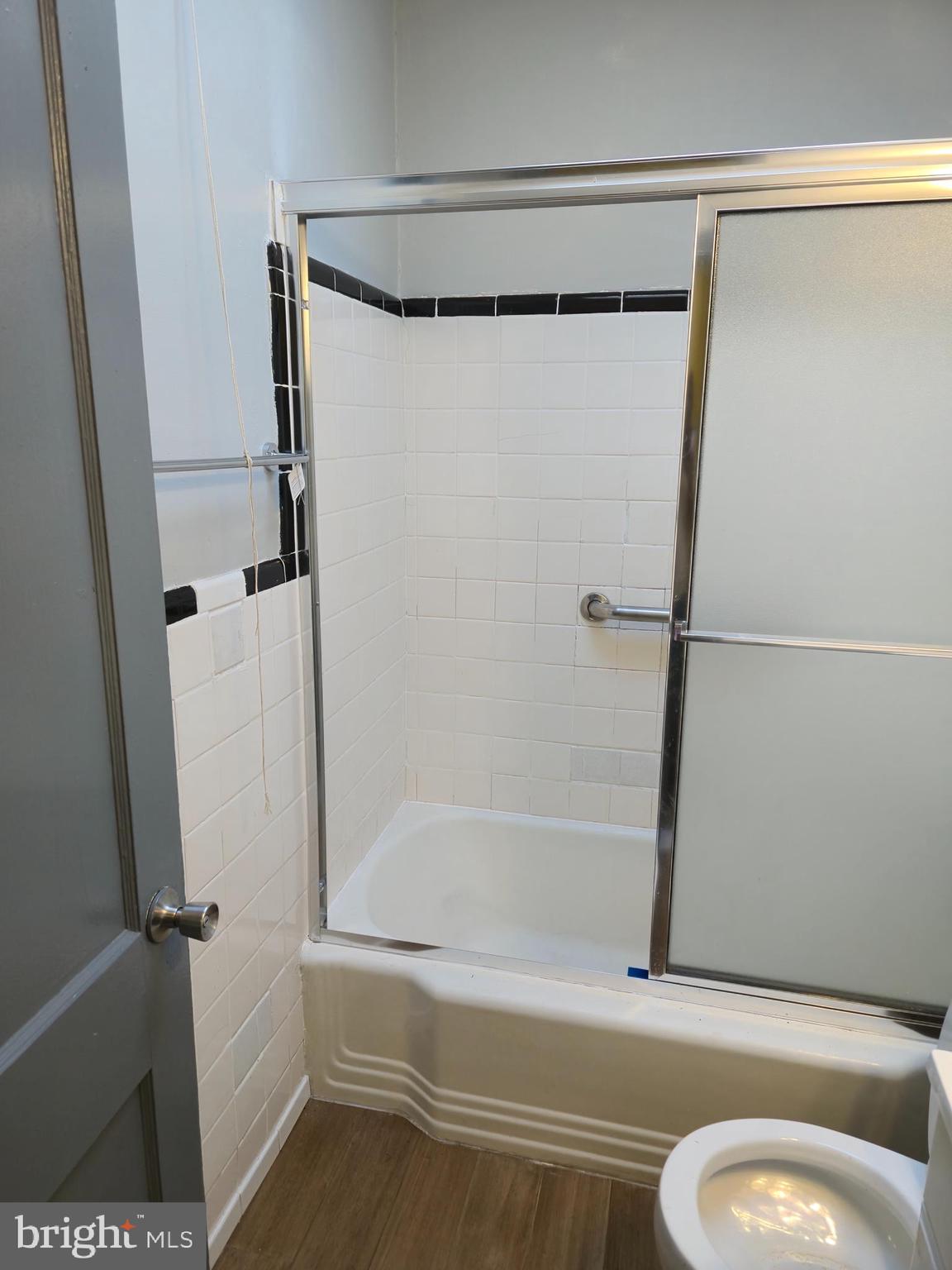 721 Roundview Road Baltimore, MD 21225 - Photo 4 of 30 a bathroom with a shower and a toilet