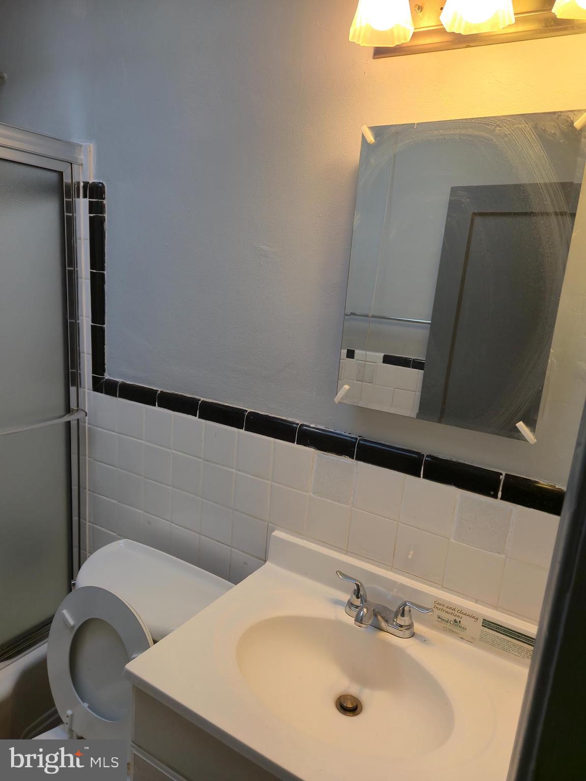 721 Roundview Road Baltimore, MD 21225 - Photo 5 of 30 a bathroom with a sink and mirror