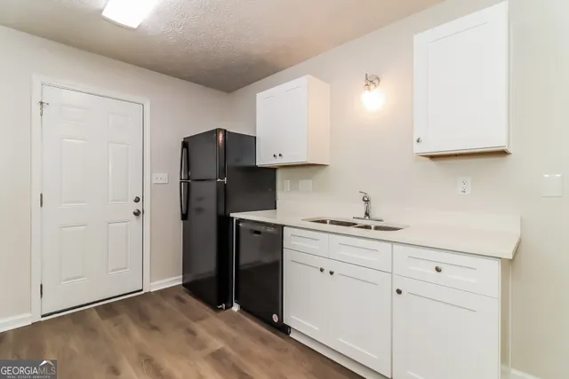 a kitchen with a refrigerator and cabinets