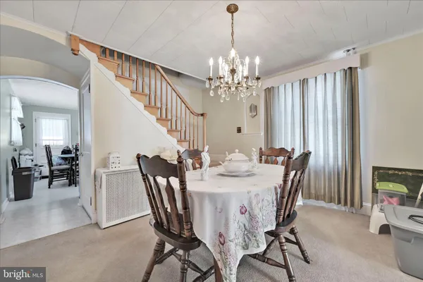 a view of a dining room with furniture and chandelier